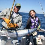 Son and daughter holding a big wahoo