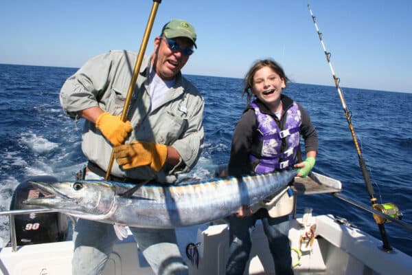 Son and daughter holding a big wahoo