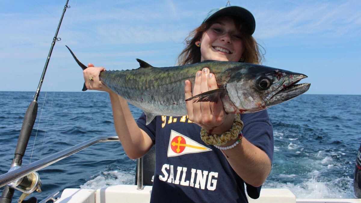 girl holding a king mackerel