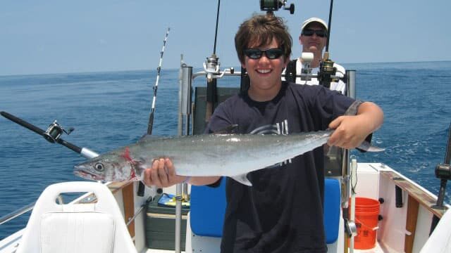 teenager holding a nice king mackerel caught in the north.