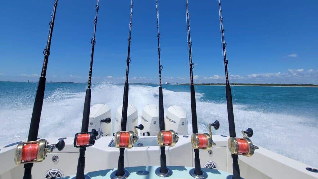 a fishing boat with four outboard motors leaving port for the fishing grounds